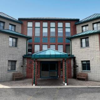 A modern building with a symmetrical design and prominent entrance.