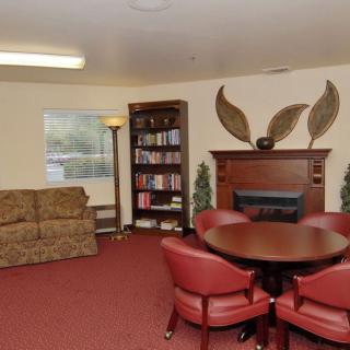 Cozy living room with a fireplace, sofa, and a seating area.