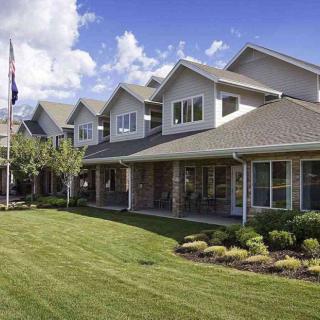 A well-maintained residential building with a manicured lawn and landscaping.