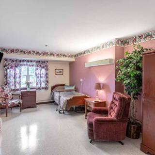 A cozy hospital room featuring comfortable seating and a well-lit ambiance.