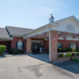 A brick building with a decorated entrance and patriotic bunting.