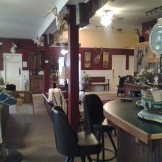 A cozy bar interior with seating and rustic decor.