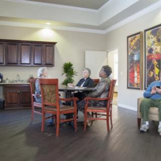 A group of seniors socializing in a cozy living room setting.