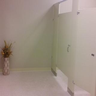 A clean and minimalistic bathroom with a flower vase.