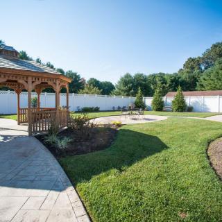 A beautifully landscaped garden with a gazebo and well-maintained lawn.