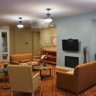 Cozy living room with comfortable seating and a fireplace.