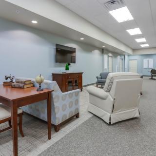 A modern living room with comfortable seating arrangements and a television.