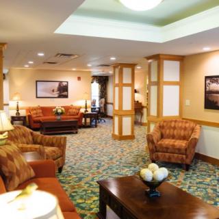 A cozy and well-furnished living room with comfortable seating and warm lighting.