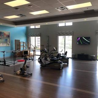 A well-equipped fitness area featuring various exercise machines and a vibrant atmosphere.