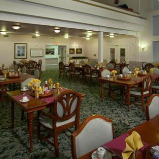 A spacious restaurant interior with neatly set tables and elegant decor.