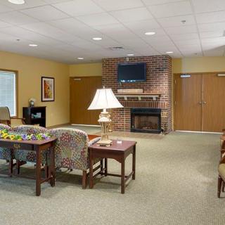 A cozy living room with a fireplace and comfortable seating.