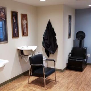 Interior of a hair salon with styling chairs and equipment.