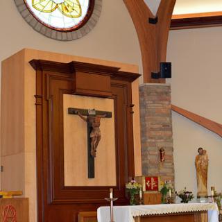 Interior view of a church featuring a wooden altar and crucifix.