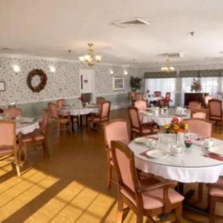 An elegantly decorated dining room with neatly arranged tables and chairs.