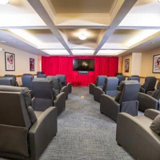 An inviting home theater setup with comfortable seating and a large screen, perfect for movie nights.
