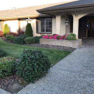 A picturesque residence featuring well-maintained landscaping and colorful flowers.