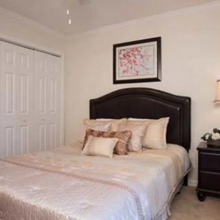 A cozy bedroom with elegant decor and a comfortable bed.