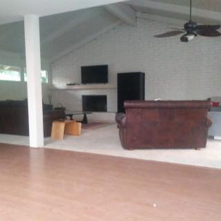 A spacious living room with modern furniture and a fireplace.