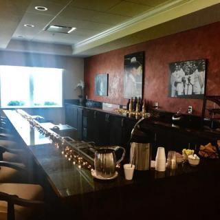 An empty bar area with seating and a well-lit counter.