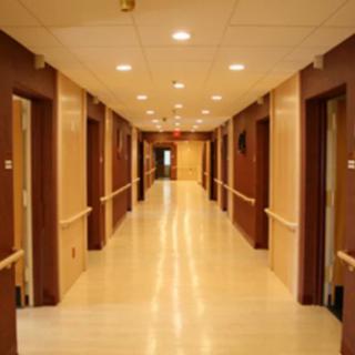 A well-lit corridor with multiple doors on either side.