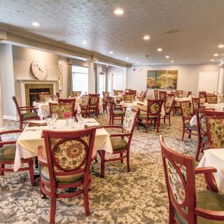 An elegant dining room with neatly arranged tables and chairs.