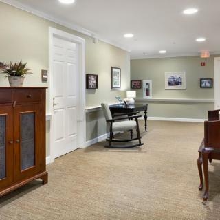 A cozy hallway with classic wooden furniture and soft lighting.