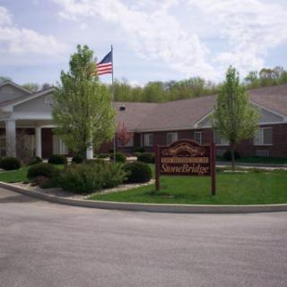 A peaceful residential community with well-maintained landscaping and an American flag.