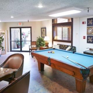 A cozy game room featuring a pool table and seating area.
