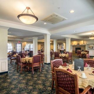 Elegant dining room setup with neatly arranged tables and chairs.
