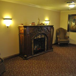 A cozy living room featuring a fireplace, comfortable seating, and warm lighting.