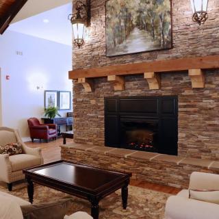 A cozy living room with a brick fireplace and comfortable seating.