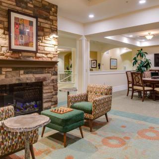 A cozy living room with a fireplace, comfortable seating, and warm interior design.