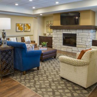 A cozy living room with comfortable seating, a fireplace, and modern decor.