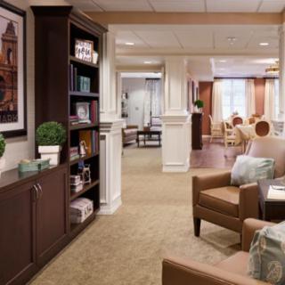 A cozy lounge area with comfortable seating and a bookshelf, designed for relaxation.