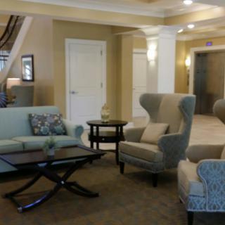 A cozy and well-furnished lobby with sofas, chairs, and a coffee table.