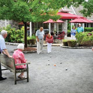 Seniors enjoying a friendly game of bocce ball in a community park.