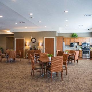 Spacious dining area with kitchen and comfortable seating.