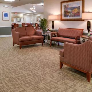 A cozy waiting room with comfortable seating arrangements and warm lighting.