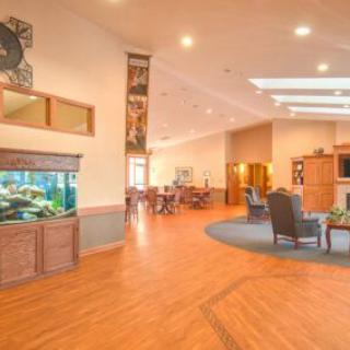 A spacious lobby with modern decor features a seating area and an aquarium.