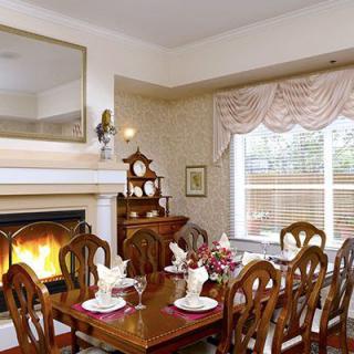 An elegant dining room with a fireplace and beautifully set table.