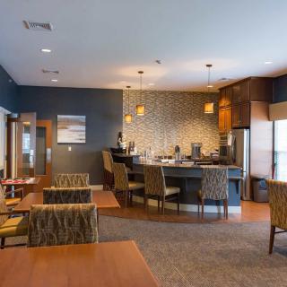 A modern cafe interior with seating and a bar area.