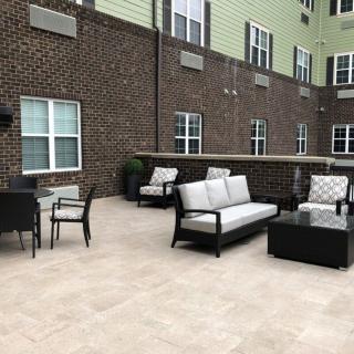 A spacious outdoor patio with comfortable seating and a modern design.