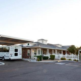 A building featuring a drive-through area with a vehicle parked alongside.