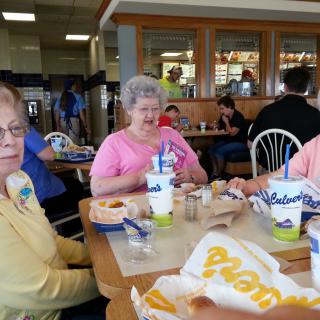 A group of people enjoying a meal together at a fast food restaurant.