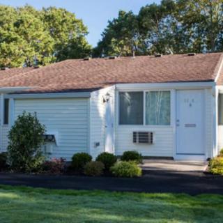 A small, single-story suburban house with a well-maintained lawn.