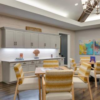 A modern dining area with stylish furniture and colorful artwork.