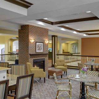 A cozy lounge area with comfortable seating and a fireplace.