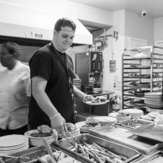 Chefs busy at work in a bustling kitchen.