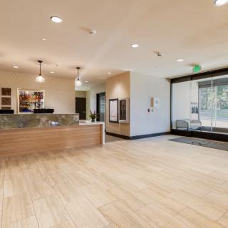Modern office lobby with a reception desk and seating area.