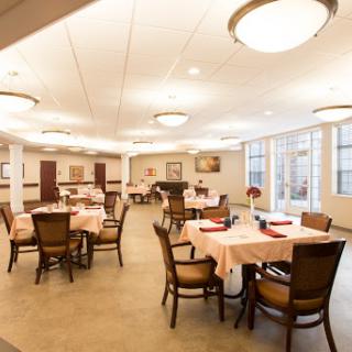 A warm and inviting dining area designed for casual meals, featuring well-arranged tables and soft lighting.